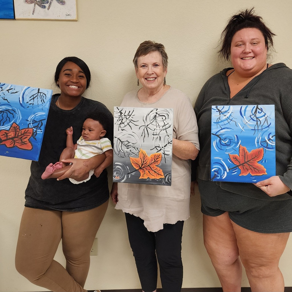 Art students holding artwork