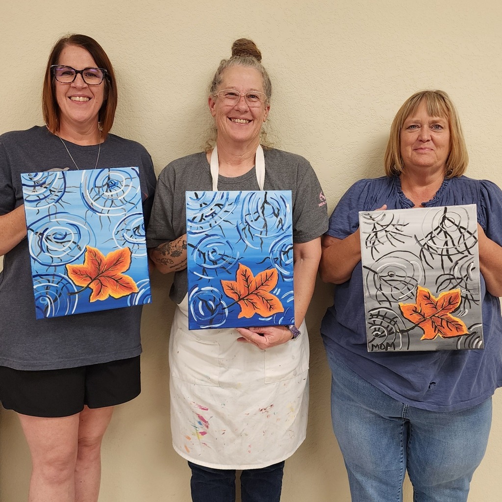 Art students holding artwork