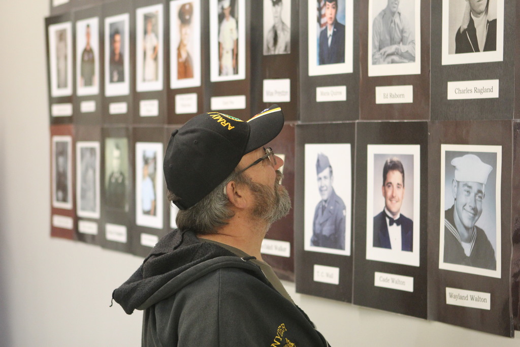 A Veterans looks at Veterans’ portraits displayed on the museum’s Wall of Honor.