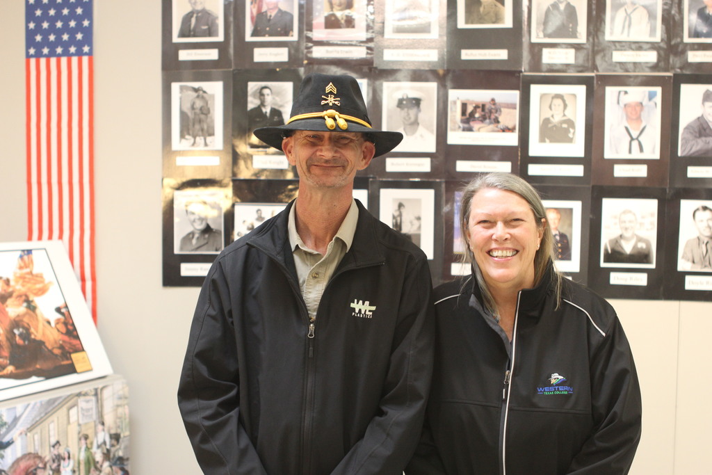Sgt. Randell and Dr. Beebe pose for a photo with the Wall of Honor in the background.