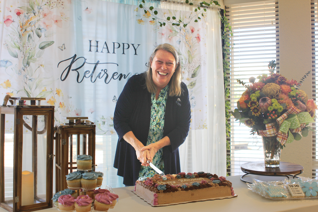 Dr. Beebe cuts her retirement cake.