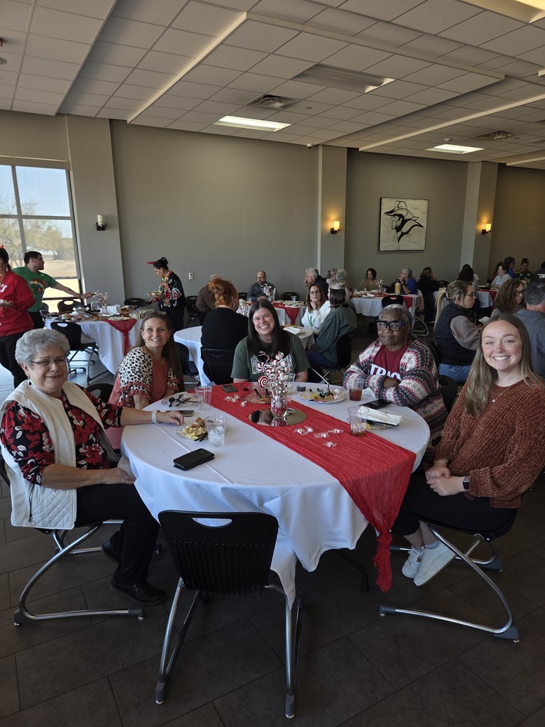 Talent Search staff seated at a round table with holiday decorations.