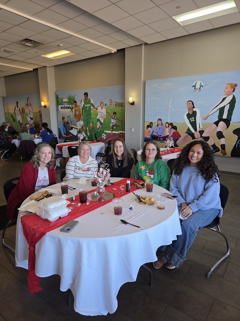 Dr. Sharp and Counseling staff seated at a round table with holiday decorations.