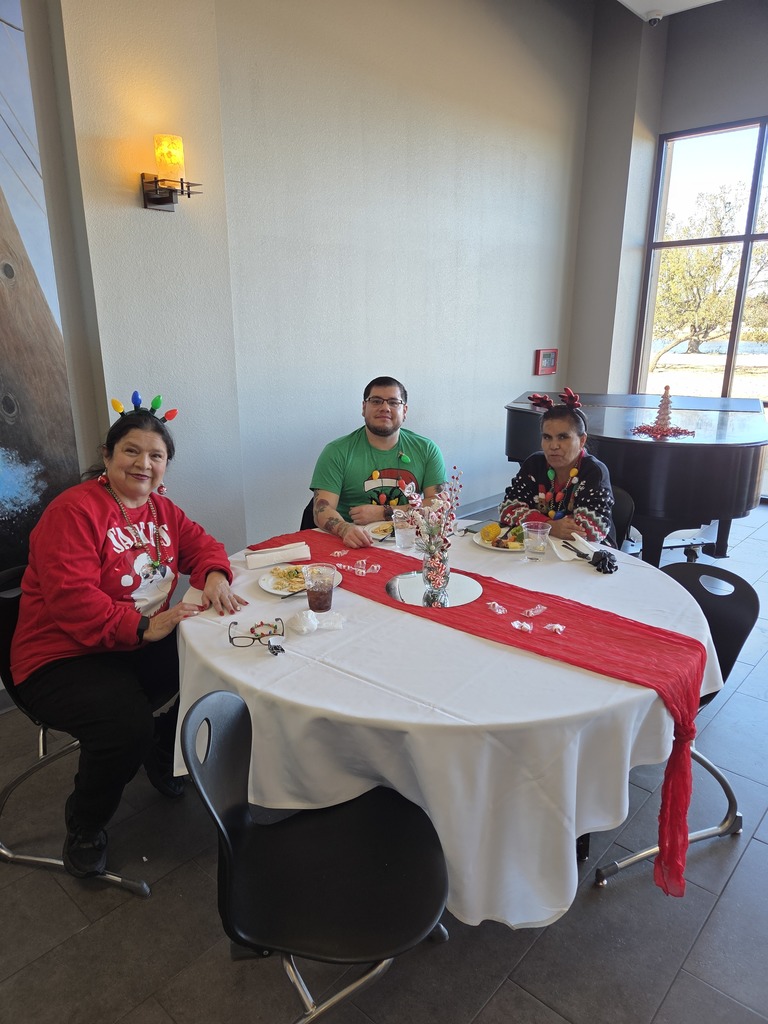 Great Western Dining employees seated at a round table with holiday decorations.