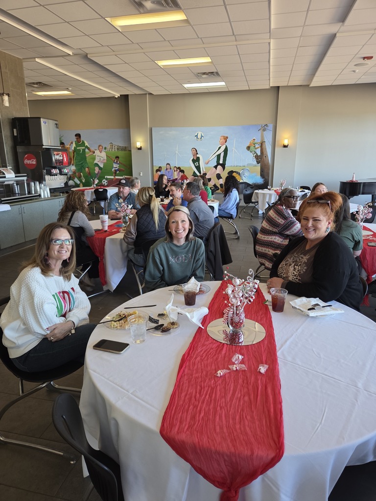Financial Aid employees seated at a round table with holiday decorations.