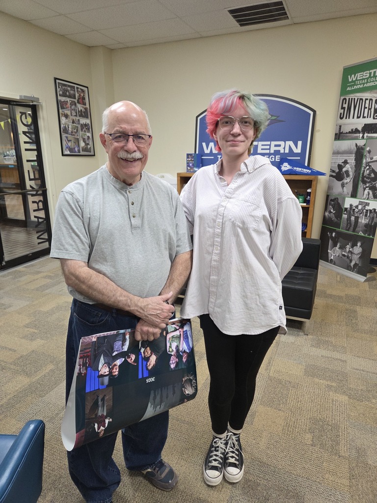 Ray Newton and Alex Welch smile for the camera in the Foundation Office.