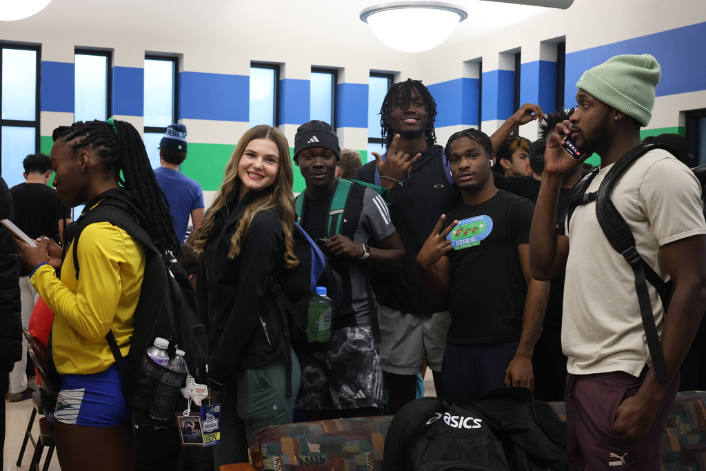 Students hamming it up for the camera while waiting in line for BBQ.