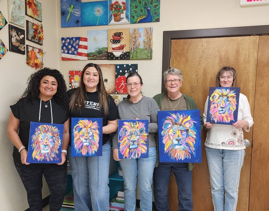 People holding paintings of colorful lion