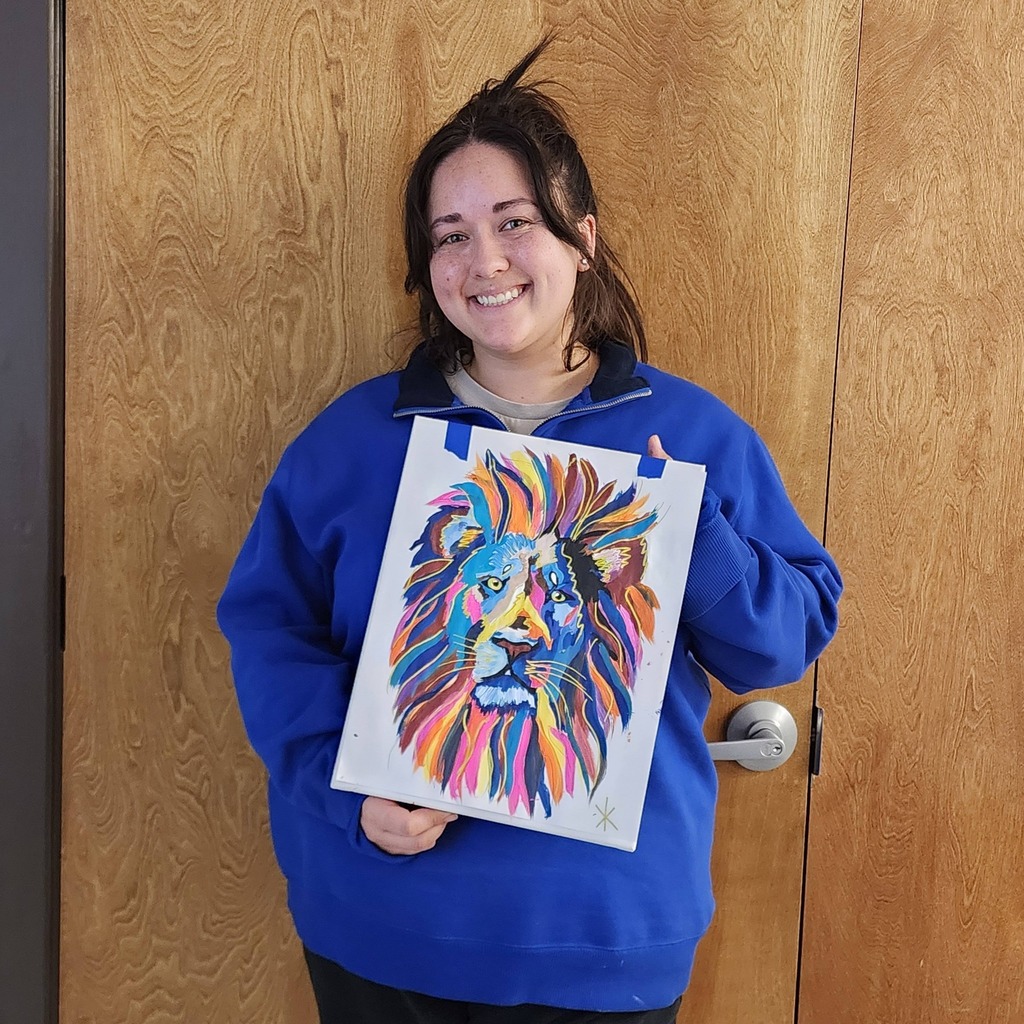 People holding paintings of colorful lion