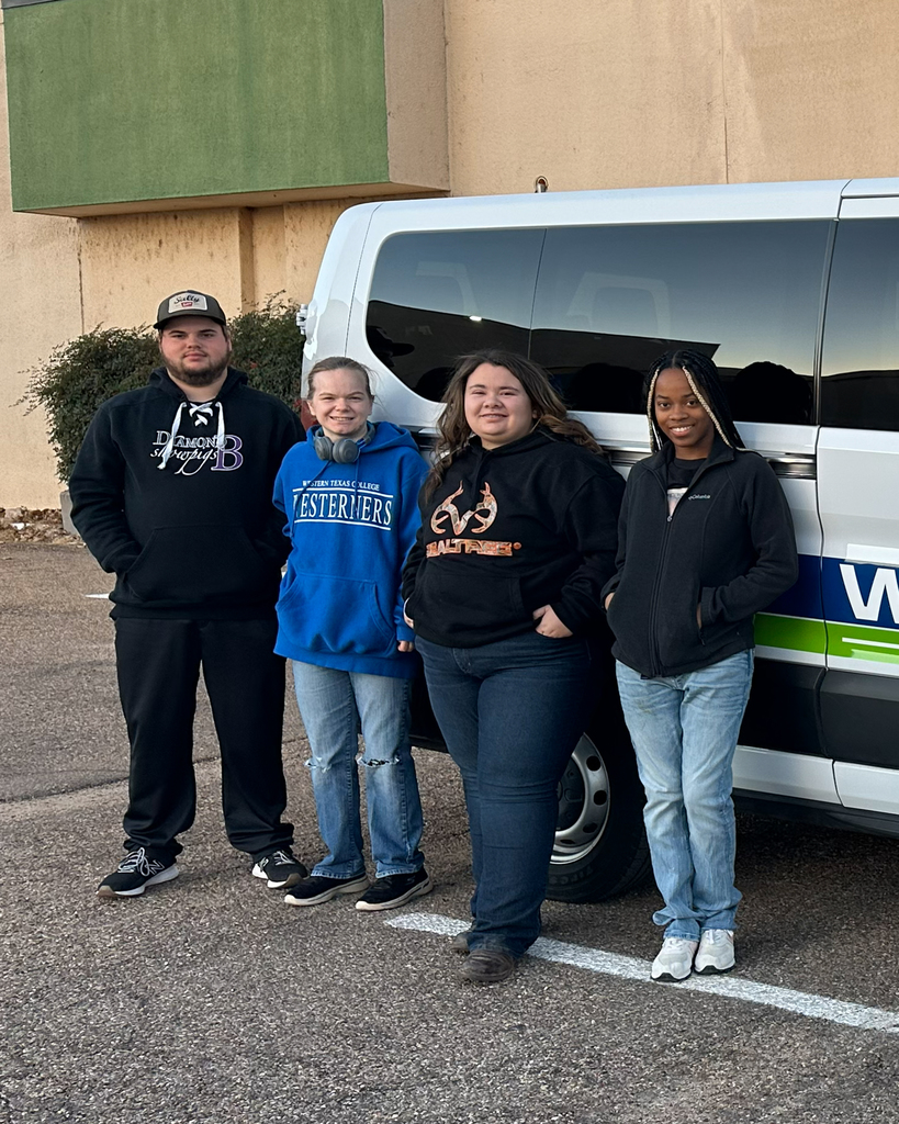 Charlie Barclay, Makayla Easley, Karcyn Hough, and Heather Spires stand in front of a WTC van.