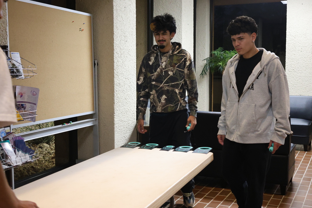 Students toss bean bags during a cornhole game at WTC Student Center Game Night.