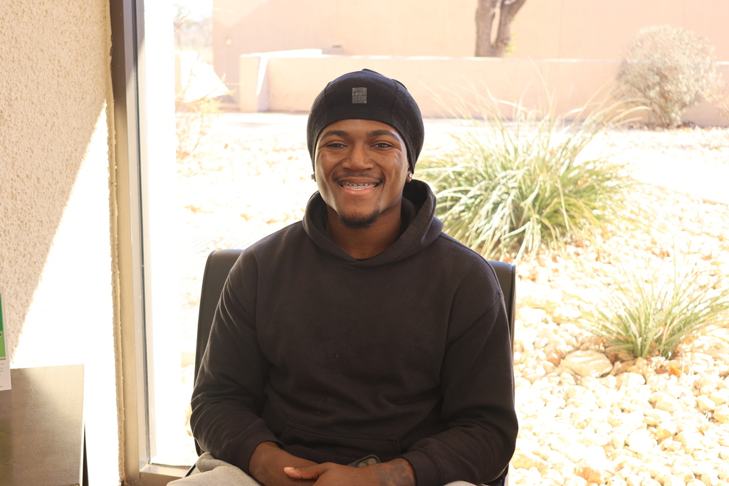 Western Texas College student smiling indoors near a window on the first day of classes.