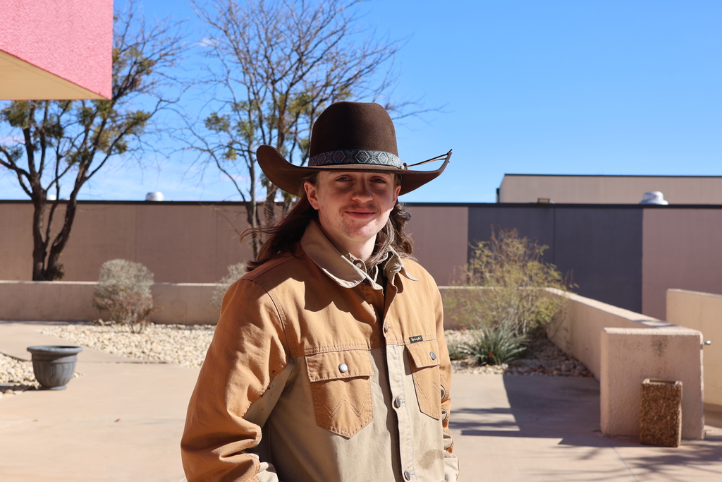 Western Texas College student wearing a cowboy hat standing outside on campus during the first day of classes.