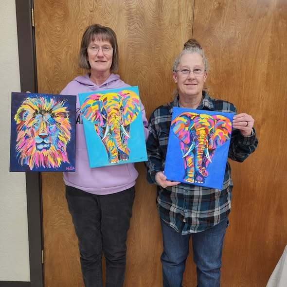 Students with painting of colorful giraffe