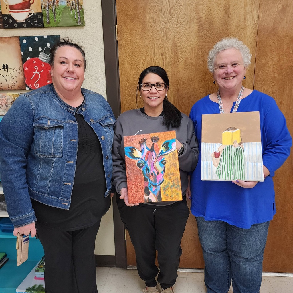 Students with painting of colorful giraffe
