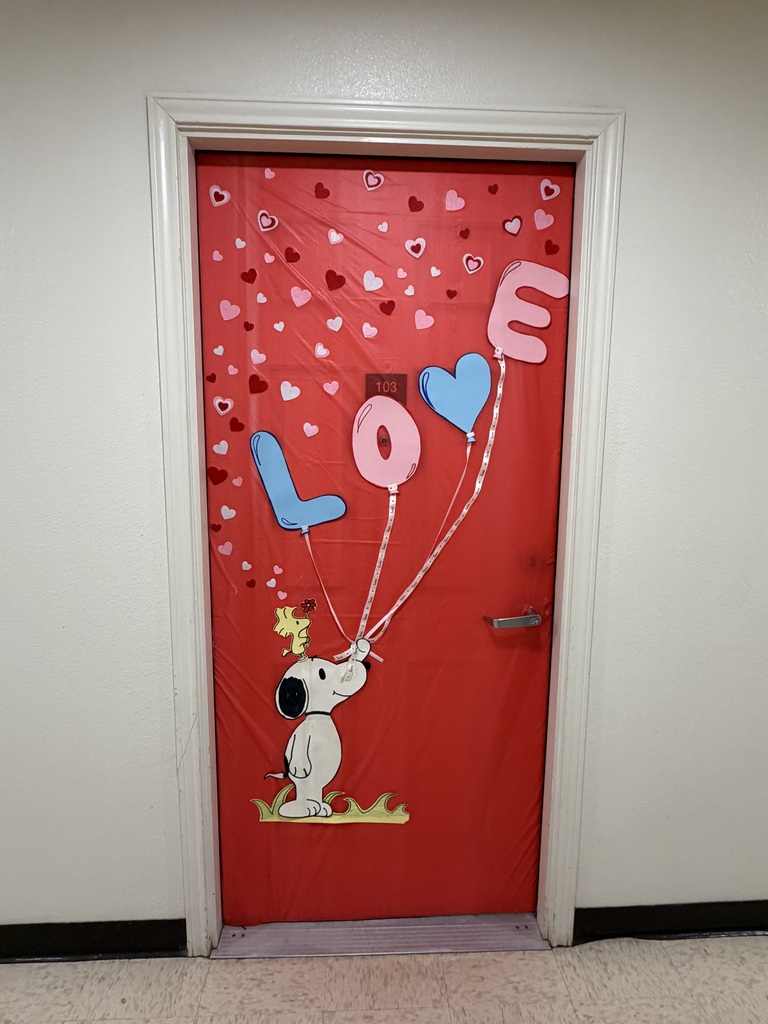 Red Valentine’s door features Snoopy holding “LOVE” balloons surrounded by floating hearts.