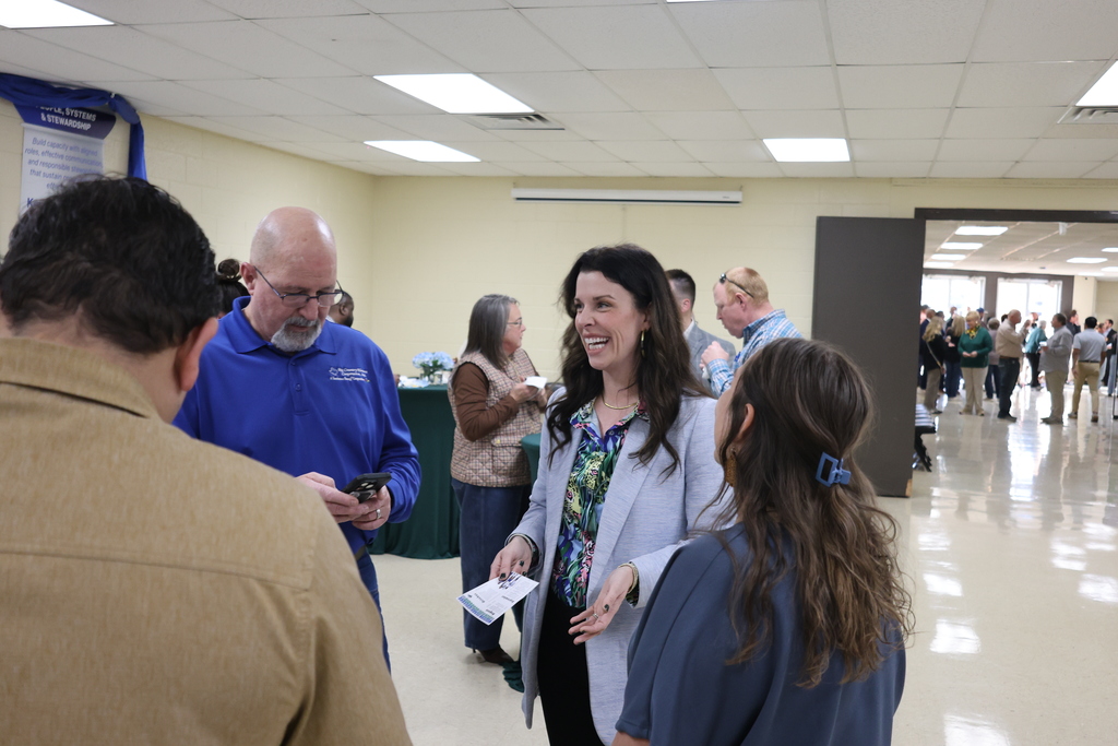 Dr. Gore speaks with guests at meet and greet event.