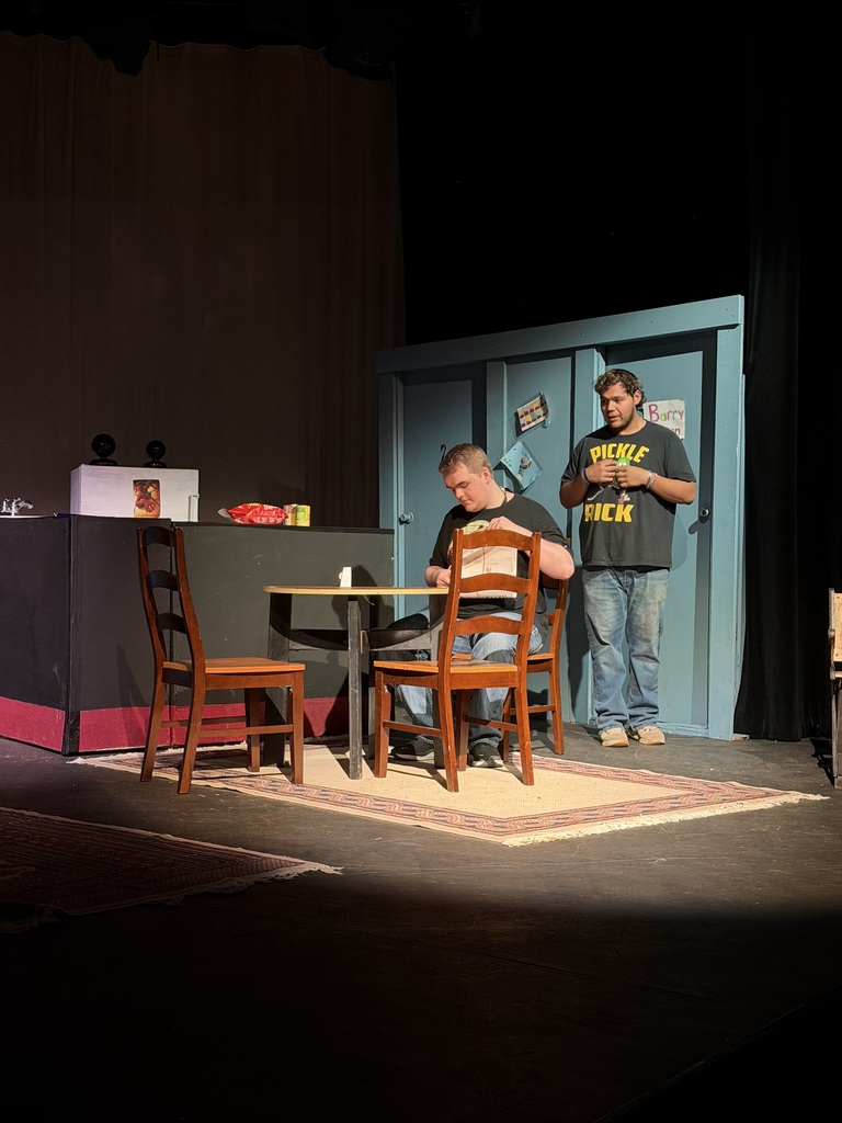 Two actors perform kitchen table scene on stage during Western Texas College production of The Boys Next Door.