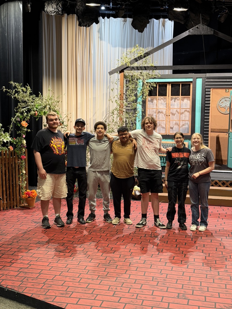 The cast and crew (minus 1) smile and pose for a photo on the set of ALL MY SONS.