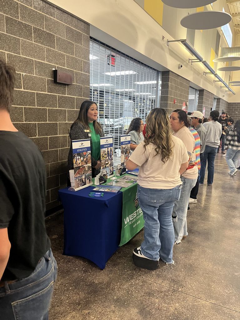 Students explore Western Texas College programs during indoor recruitment event.