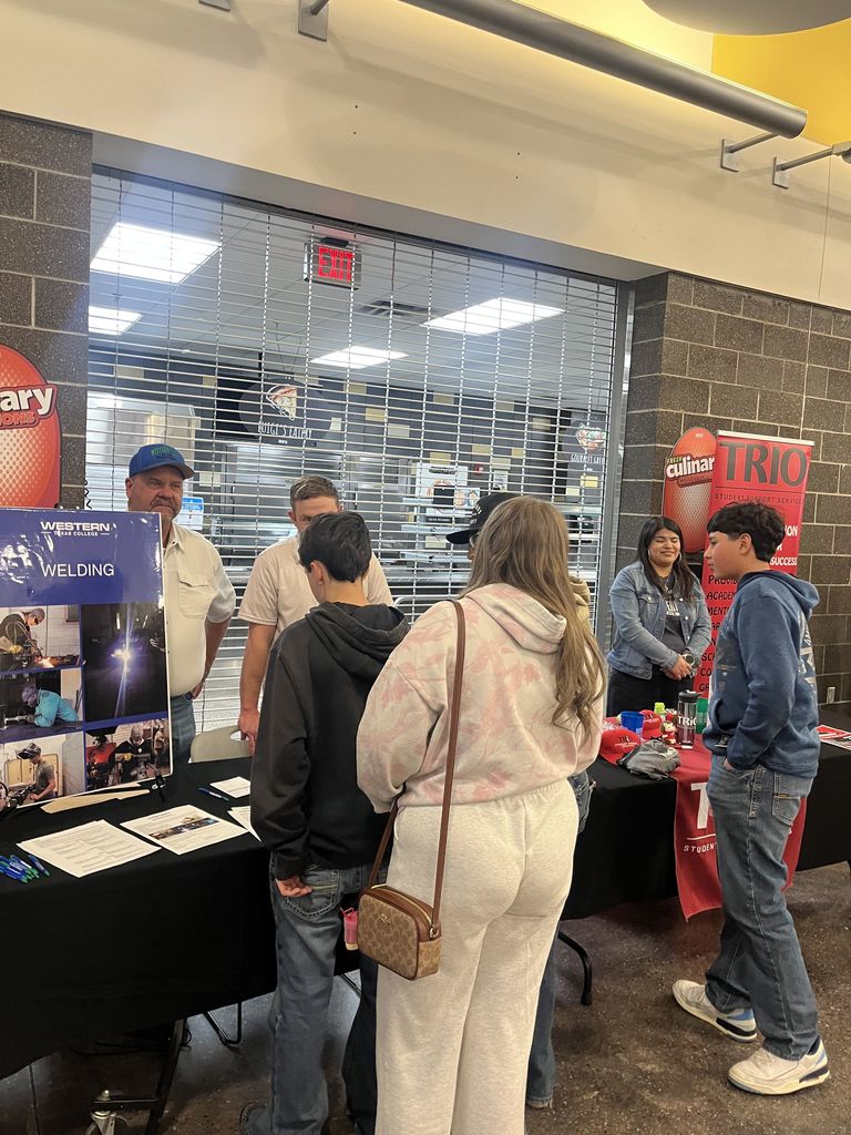 Students visit welding and TRIO tables during Western Texas College event.