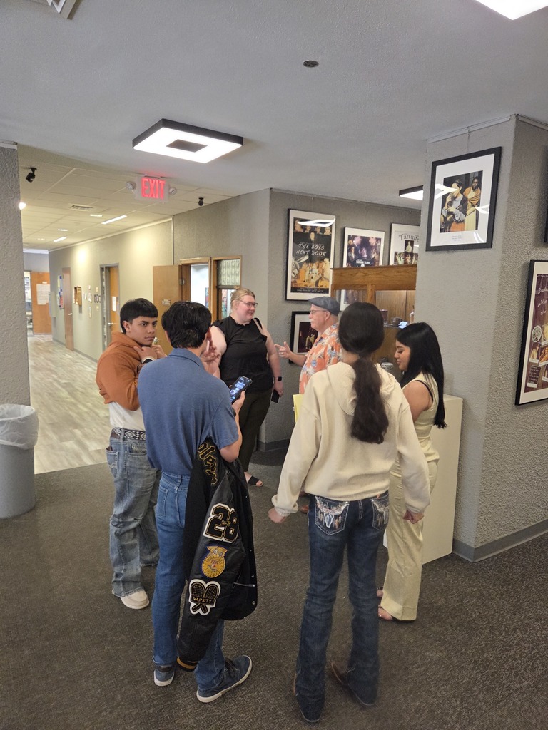 Students and guests visit near theater lobby entrance after campus play