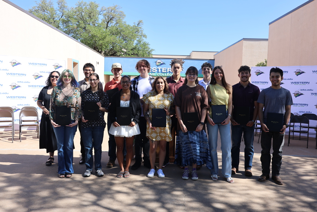 Students pose with award folders during Western Texas College Student Awards Ceremony outdoors.