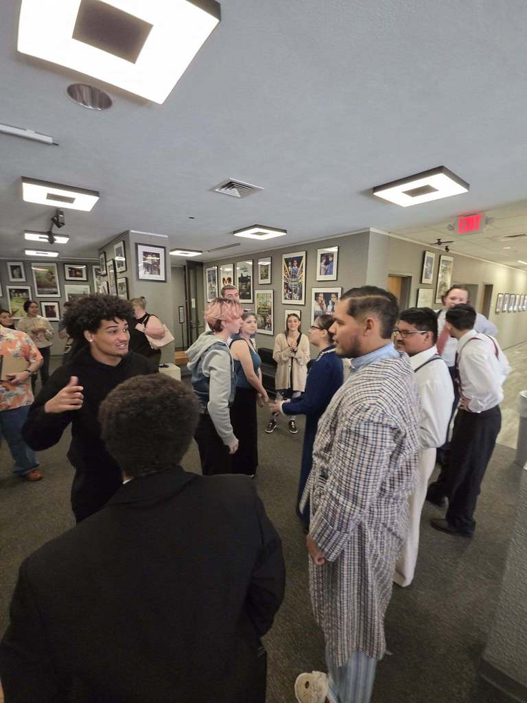 Students and guests gathering in the hallway