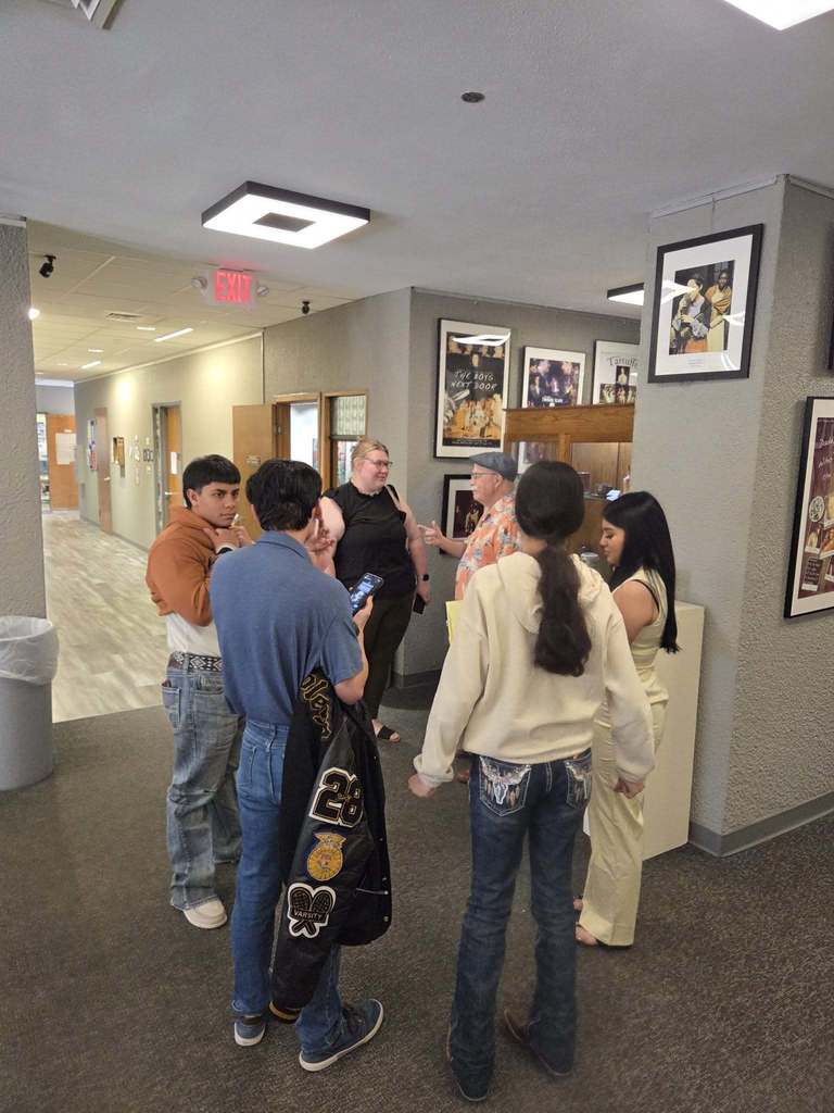 Students and guests gathering in the hallway