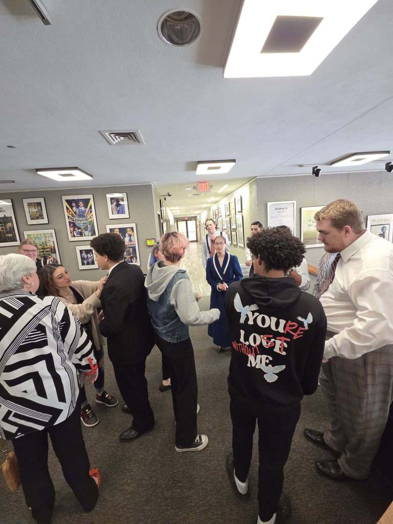 Students and guests gathering in the hallway