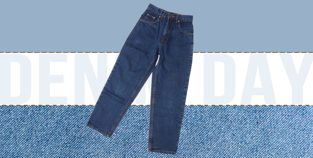 A pair of denim jean sits on a denim striped background with the words "Denim Day" in faint letters.