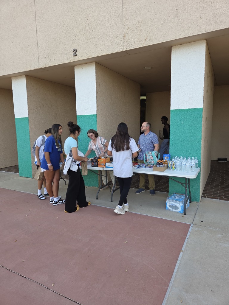 WTC employees hand out snacks and bottled water to students outside Library Building 2.