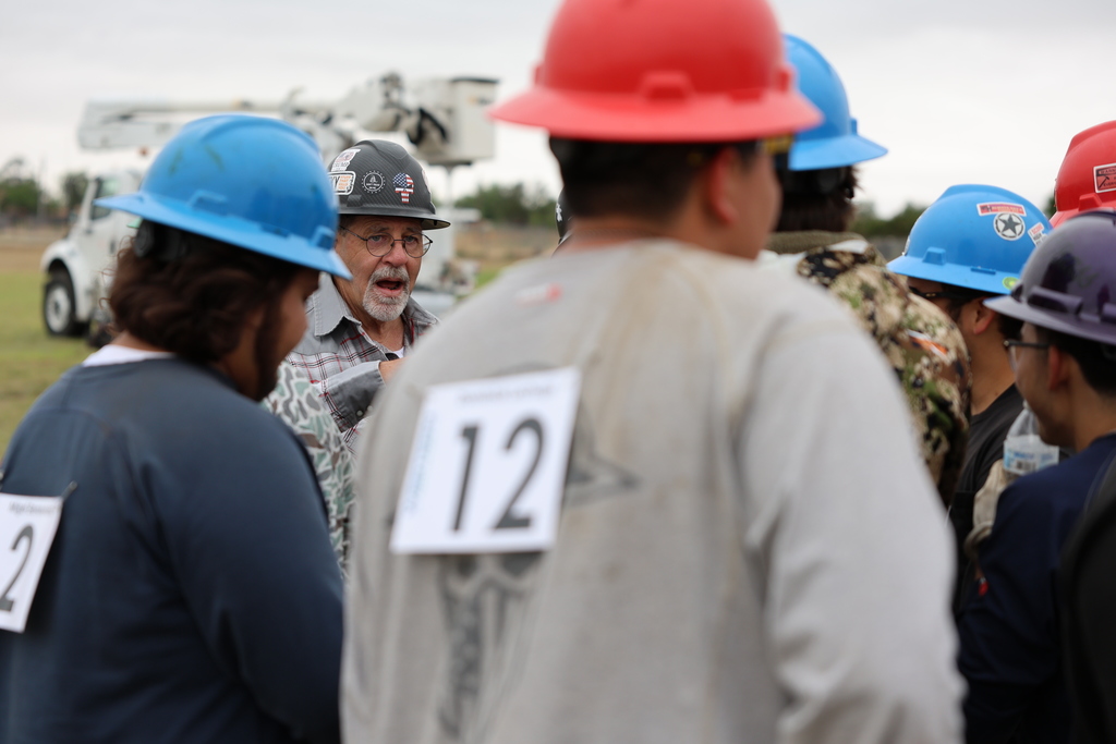 Instructor addresses students wearing numbered safety gear.