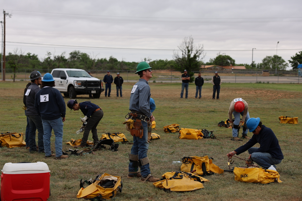 Students prepare climbing gear before lineworker skills test.