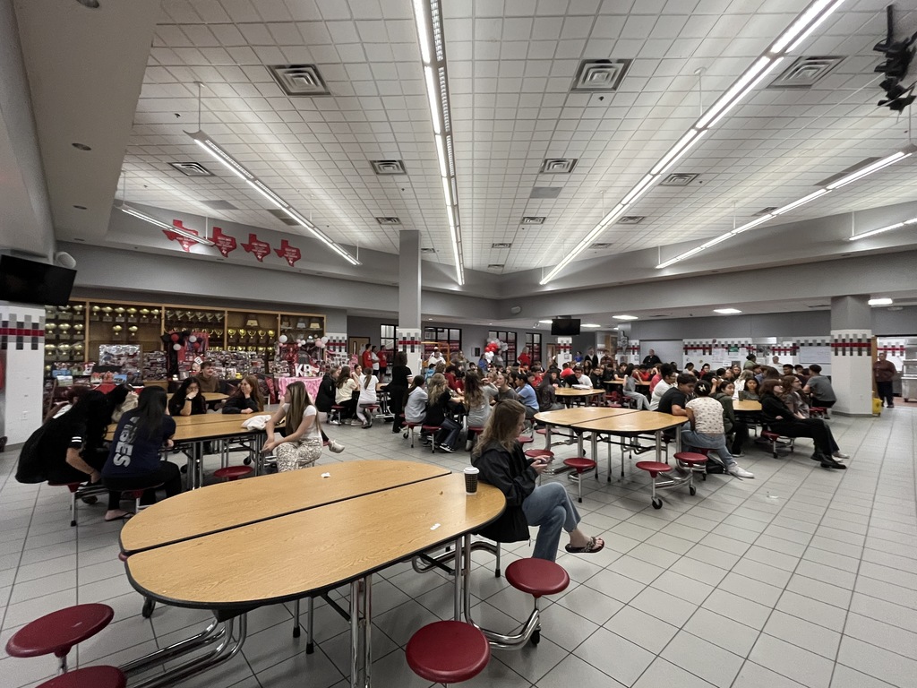 Hermleigh High School students sit at round  tables waiting for the announcement.