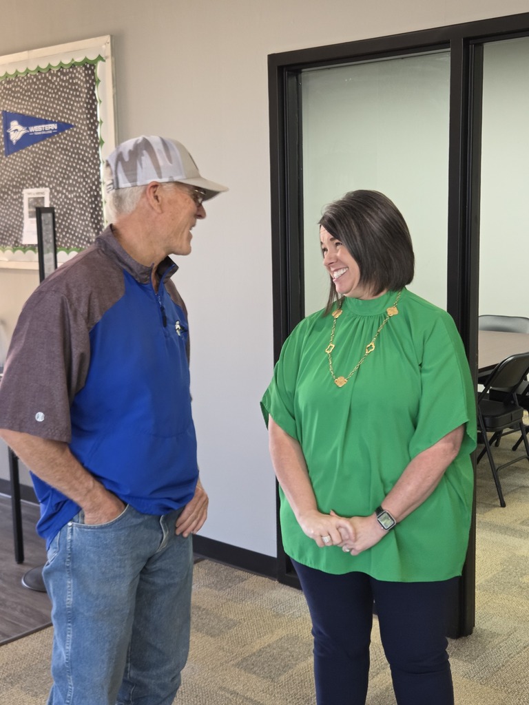 Dr. Perryman smiles at Greg Rhodes during conversation.