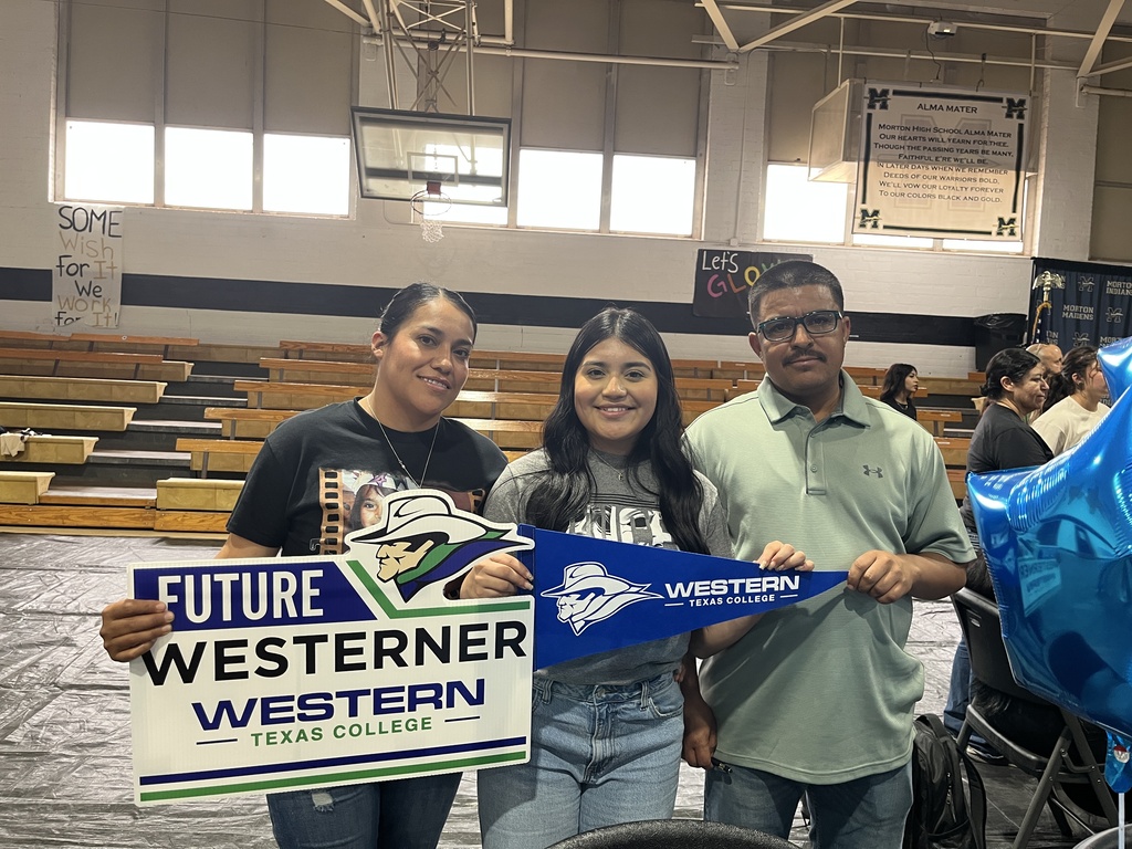 Future Westerner and family hold pennant and sign with college logos.
