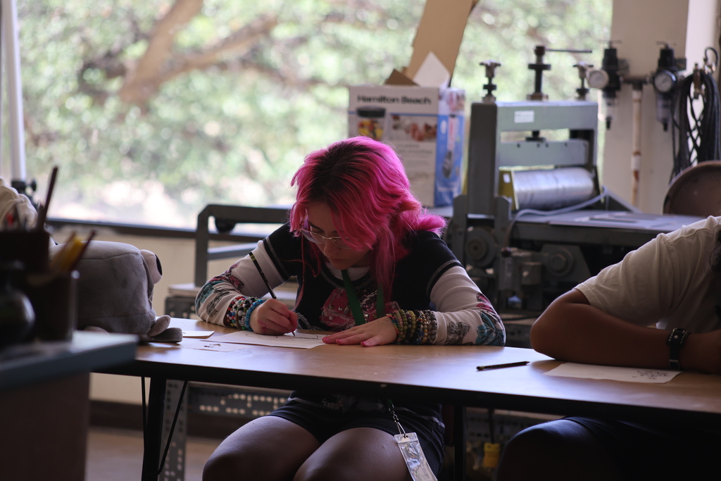 Student works on art piece during summer program.