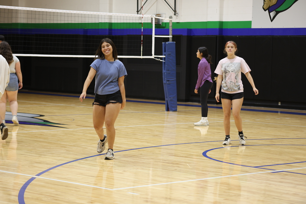 Students participate in a recreational volleyball game inside the WTC gym during summer campus activities.