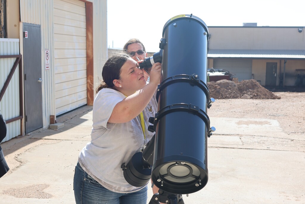 Student looking through a telescope