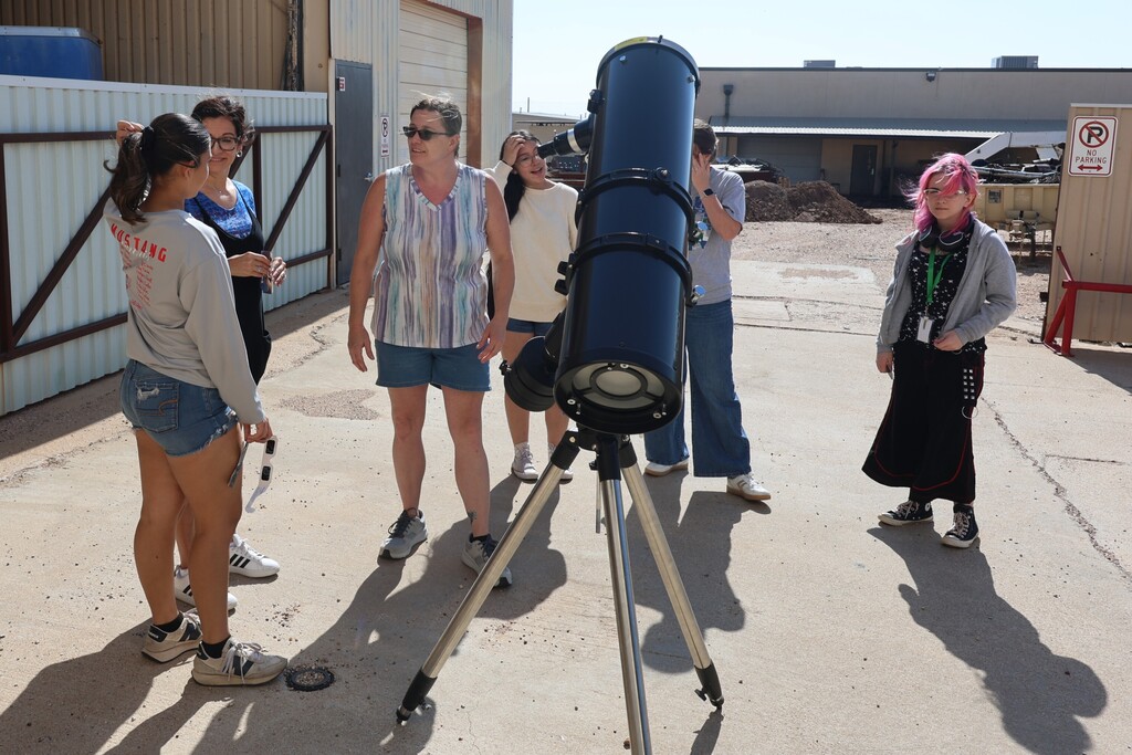 Students being taught about the telescope and sun.