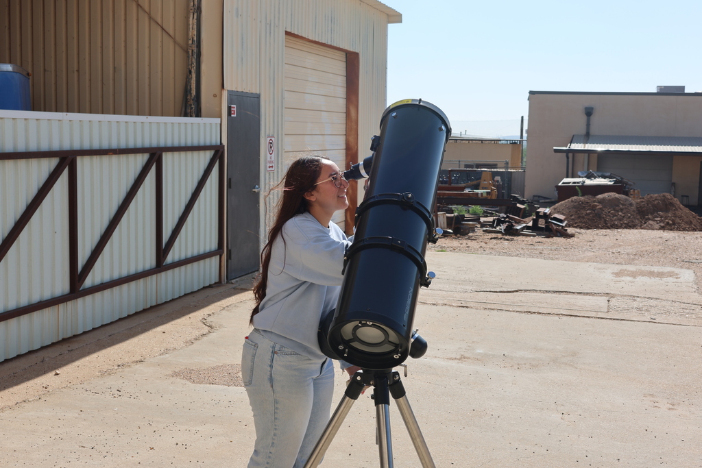 Student looking through a telescope