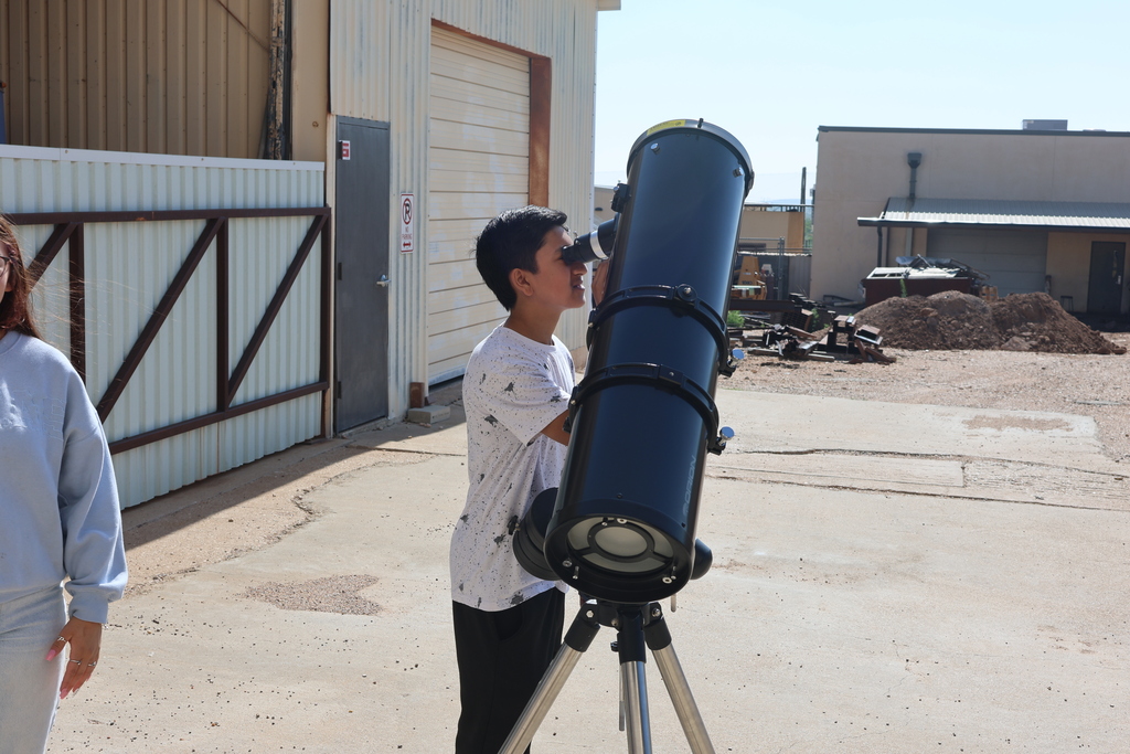Student looking through a telescope