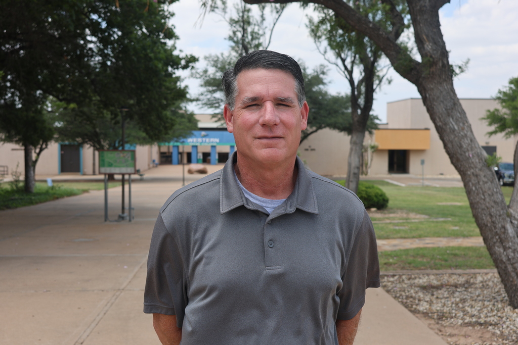 Shawn Fonville, Vice President for Career and Technical Education and Continuing Education, stands on the front of the Western Texas College campus.