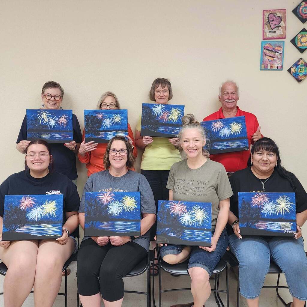 Students with paintings of fireworks