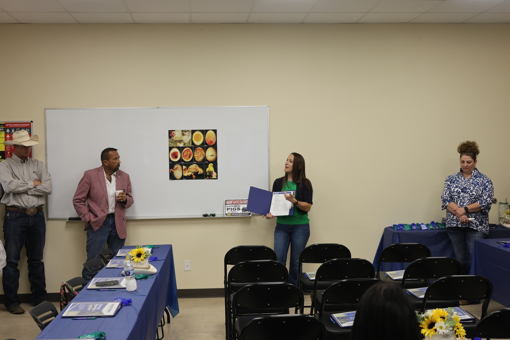 A Western Texas College representative welcomes visitors inside the Agricultural & Rodeo Complex classroom.