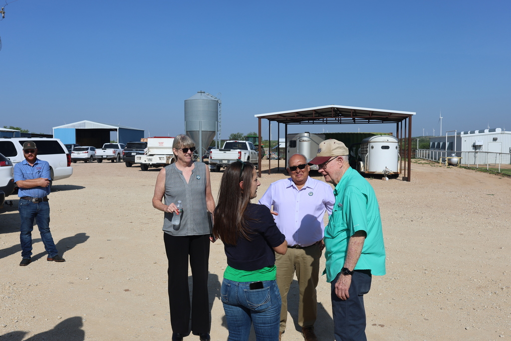 Visitors gather outside the Western Texas College Agricultural & Rodeo Complex during an agriculture program tour.