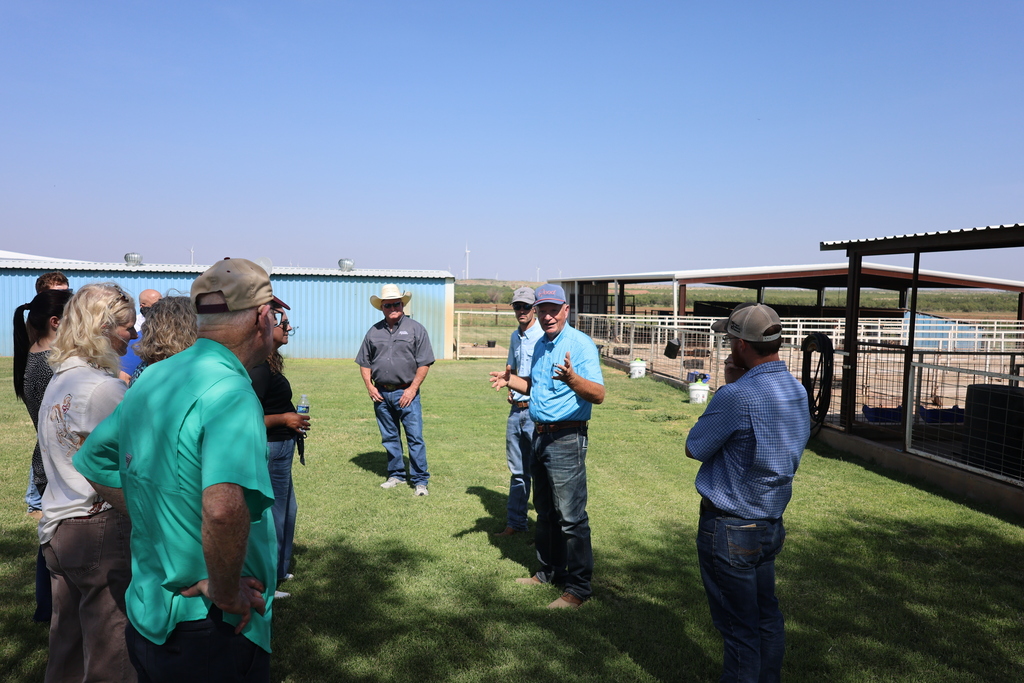 A guide speaks with visitors during a tour of the Western Texas College Agricultural & Rodeo Complex.