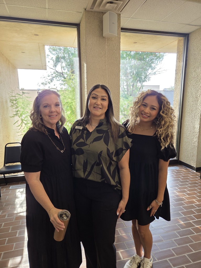 Three Western Texas College employees smile together in the campus lobby during Welcome Back activities.