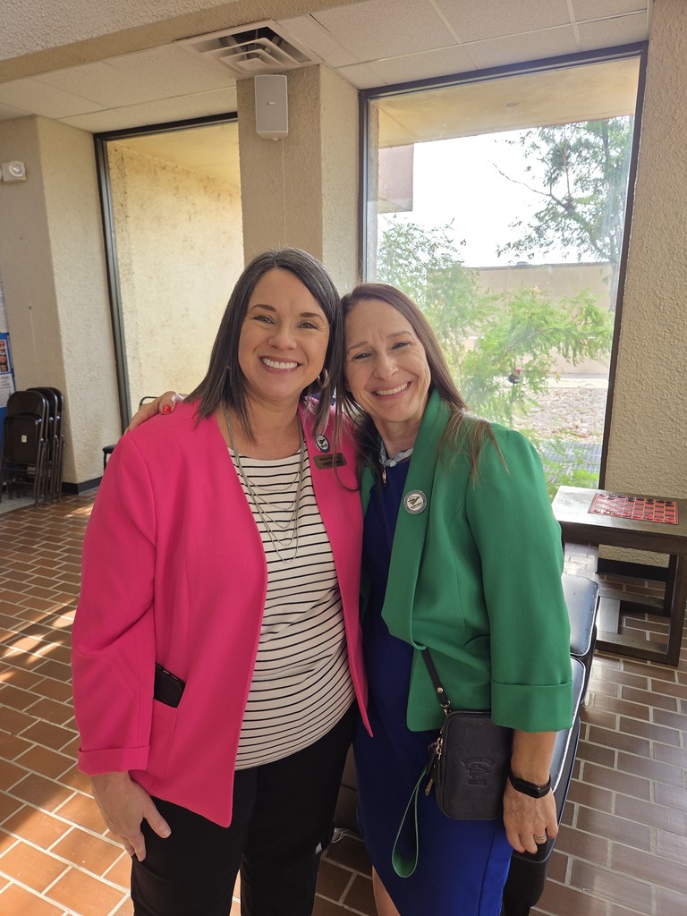 Two Western Texas College employees smile together in the campus lobby during Welcome Back activities.
